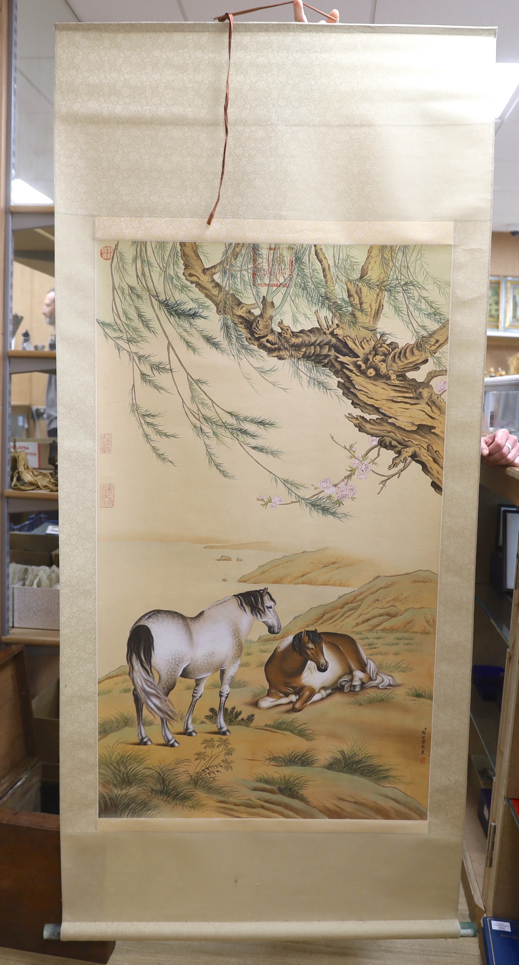 After Giuseppe Castiglione, a Chinese style scroll painting of horses, 188cm in length overall